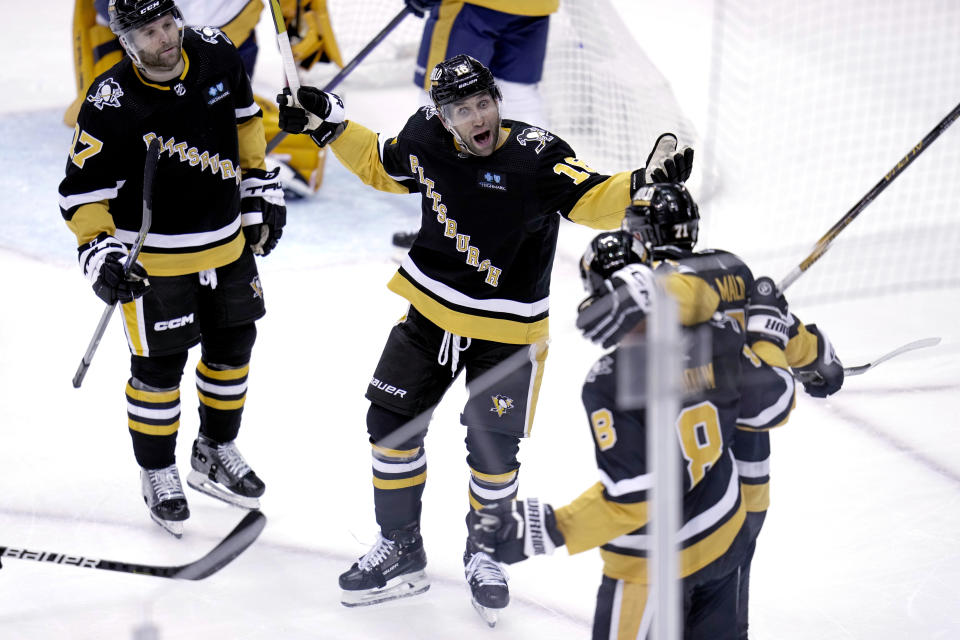 Pittsburgh Penguins' Jason Zucker (16) celebrates his goal against the Nashville Predators during the second period of an NHL hockey game in Pittsburgh, Thursday, March 30, 2023. (AP Photo/Gene J. Puskar)