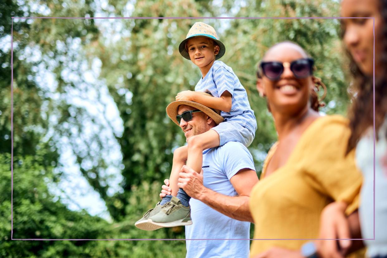  Days out in Kent illustrated by a family walking togeth in a forest with a kid on a man's shoulders 