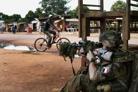 A French military sniper readies his rifle in Bangui December 8, 2013. REUTERS/Herve Serefio