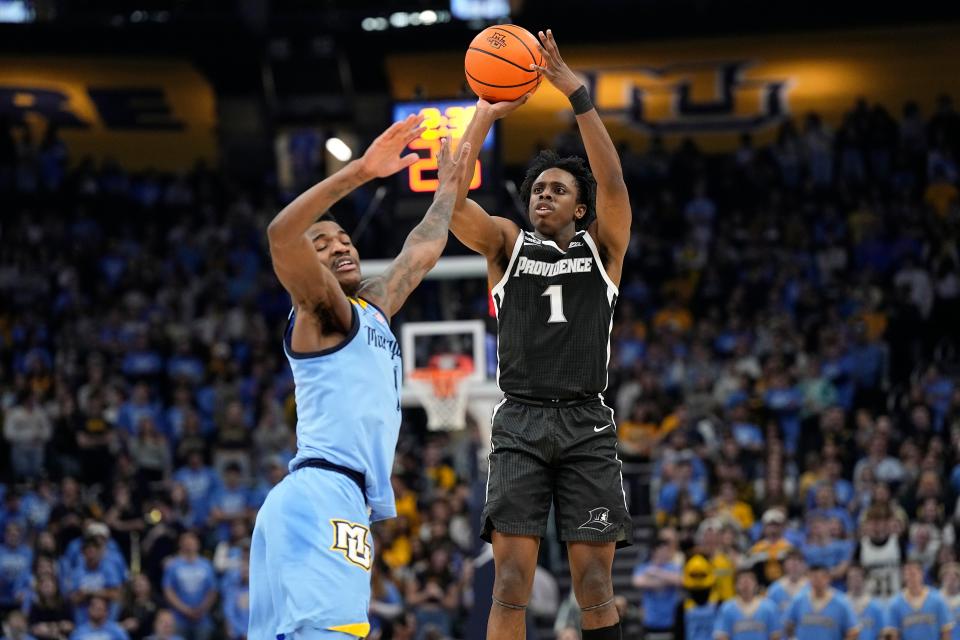 Providence guard Jayden Pierre shoots over Marquette's Kam Jones during the first half.