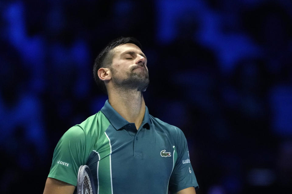 Serbia's Novak Djokovic reacts during the singles tennis match against Italy's Jannik Sinner, of the ATP World Tour Finals at the Pala Alpitour, in Turin, Italy, Tuesday, Nov. 14, 2023. (AP Photo/Antonio Calanni)