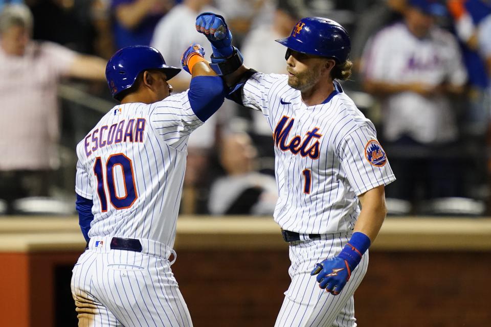 New York Mets' Jeff McNeil (1) celebrates with Eduardo Escobar (10) after hitting a home run against the Cincinnati Reds during the fourth inning of a baseball game Tuesday, Aug. 9, 2022, in New York. (AP Photo/Frank Franklin II)