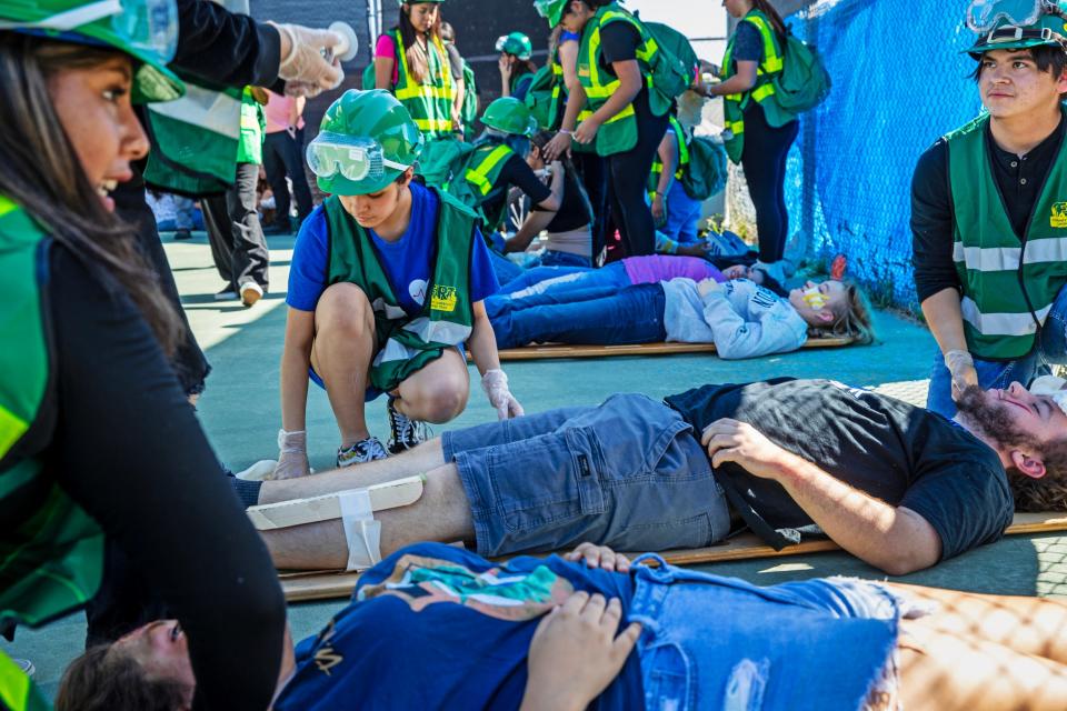 Health and Environmental Academy of Learning students at Cathedral City High School practice how to take care of injured students if an earthquake were to happen during the Great Shakeout Drill at the school in Cathedral City, Calif., on Thursday, October 19, 2023.