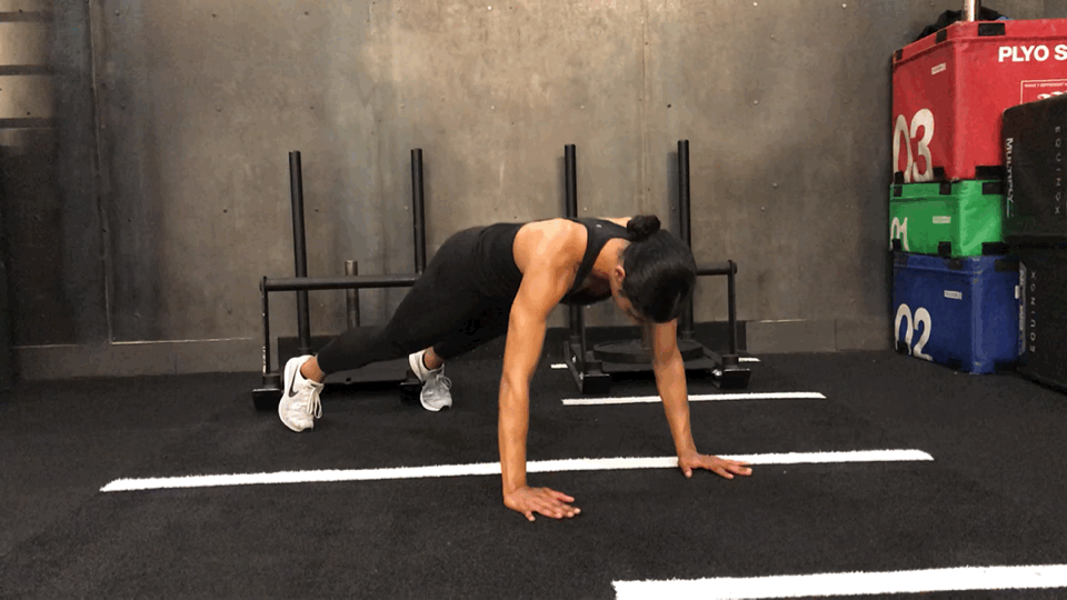 <ul> <li>Come into plank position with your arms and legs straight, shoulders above the wrists.</li> <li>Take a breath in, and as you exhale, bend your elbows out to the sides and lower your chest toward the ground. Stop as soon as your shoulders are in line with your elbows. Inhale to straighten your arms.</li> <li>Maintaining a plank position, lift your left hand and tap your right shoulder. Place your left hand back on the ground. Repeat with the right hand. Keep your hip bones pointing toward the floor to prevent rotating your torso. </li> <li>This counts as one rep.</li> </ul> <p>Tip: To modify, perform the push-up with your knees on the floor.</p>