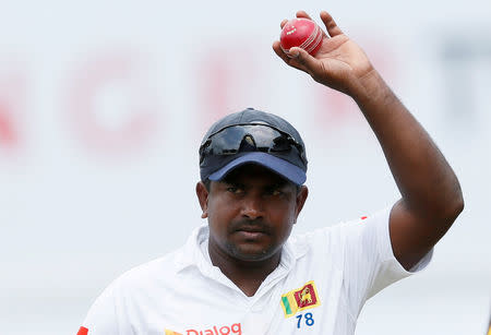 FILE PHOTO: Cricket - Sri Lanka v South Africa -Second Test Match - Colombo, Sri Lanka - July 23, 2018 - Sri Lanka's Rangana Herath shows the ball to celebrate taking six wickets after Sri Lanka won the test series. REUTERS/Dinuka Liyanawatte/File Photo