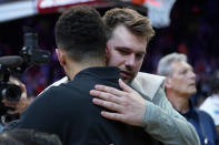 Dallas Mavericks guard Luka Doncic embraces Phoenix Suns guard Devin Booker, left, after Game 7 of an NBA basketball Western Conference playoff semifinal, Sunday, May 15, 2022, in Phoenix. The Mavericks defeated the Suns 123-90. (AP Photo/Matt York)