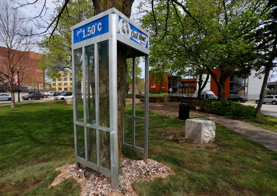 A sculpture titled "Call NOW!" by artist Mike Salisbury in Downtown Springfield is part of the 2022-2023 collection of Sculpture Walk Springfield.