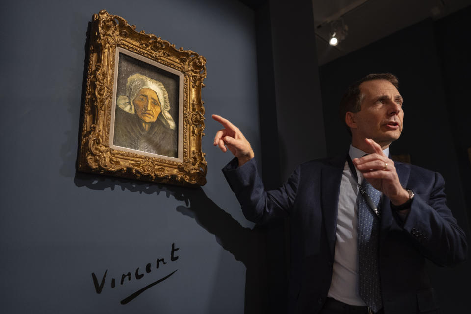 Bill Rau, president of M.S. Rau gallery, is interviewed next to Dutch master Vincent van Gogh's painting titled "Head of a Peasant Woman in a White Headdress", one of the highlights of the European Fine Art Foundation, known by its acronym TEFAF, in Maastricht, southern Netherlands, Thursday, March 7, 2024. (AP Photo/Peter Dejong)