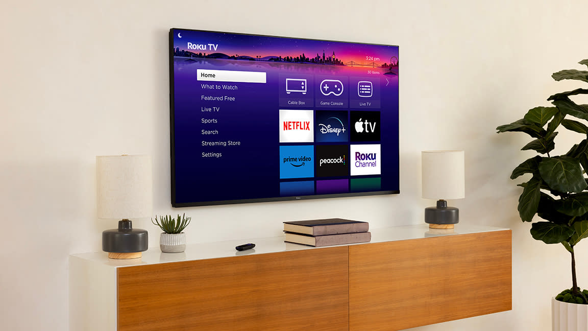  Roku Pro series TV mounted to wall in living room. 