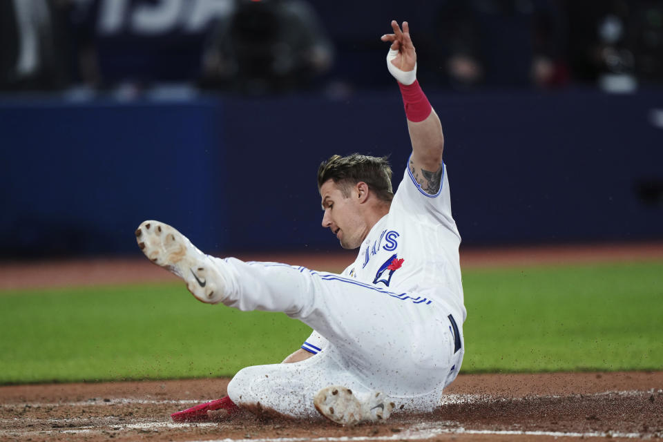 Toronto Blue Jays' Tyler Heineman scores against the Kansas City Royals during the seventh inning of a baseball game Friday, Sept. 8, 2023, in Toronto. (Nathan Denette/The Canadian Press via AP)