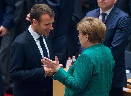 French President Emmanuel Macron and German Chancellor Angela Merkel take part in a European Union summit in Brussels, Belgium June 28, 2018. Stephanie Lecocq/Pool via REUTERS