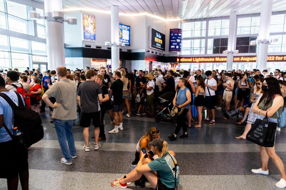 People wait to board the Staten Island Ferry in the Whitehall Terminal, Thursday, Aug. 4, 2022, in New York. (AP Photo/Julia Nikhinson)