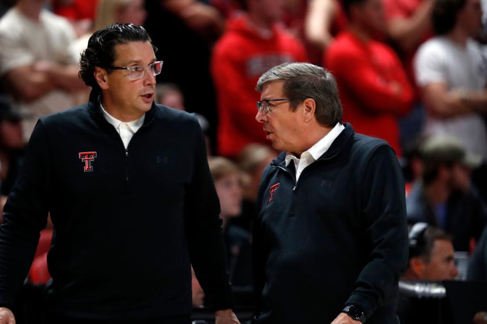 Texas Tech coach Mark Adams, right, talks to associate coach Barret Perry during the second half of an NCAA college basketball game against North Florida, Tuesday, Nov. 9, 2021, in Lubbock, Texas.