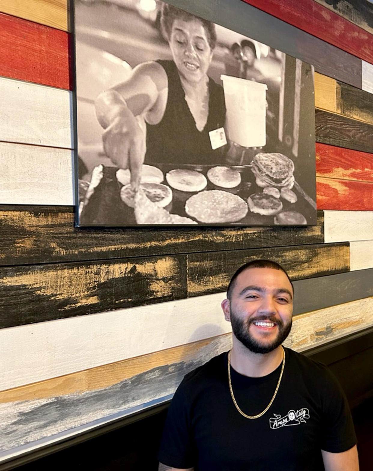 Image: Brandon Klinger at The Arepa Lady, with Maria Cano pictured in photo  (Courtesy Raul Reyes)