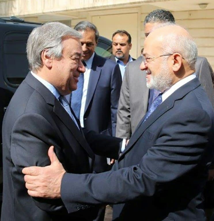 A handout picture released by the UN mission for Iraq shows UN chief Antonio Guterres (L) being welcomed to Baghdad by Foreign Minister Ibrahim al-Jafari on March 30, 2017