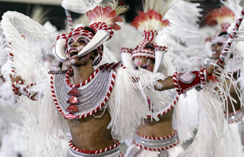 Carnival dancers perform during a parade by the Mocidade Alegre samba school in Sao Paulo, Brazil, early Sunday Feb. 19, 2012. Carnival runs Feb. 17-21. (AP Photo/Andre Penner)