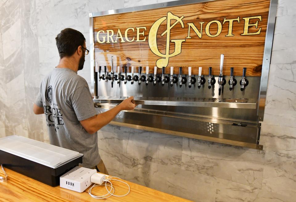 Jeremy Baker replaces the screen on his tap tray as he puts the final touches on Grace Note Brewing, his craft brewery located in the Windward Sadler Point Marina near the Ortega River Wednesday, October 11, 2023. When opened he initially plans to have four of his beers on tap as well as offerings from other microbreweries.