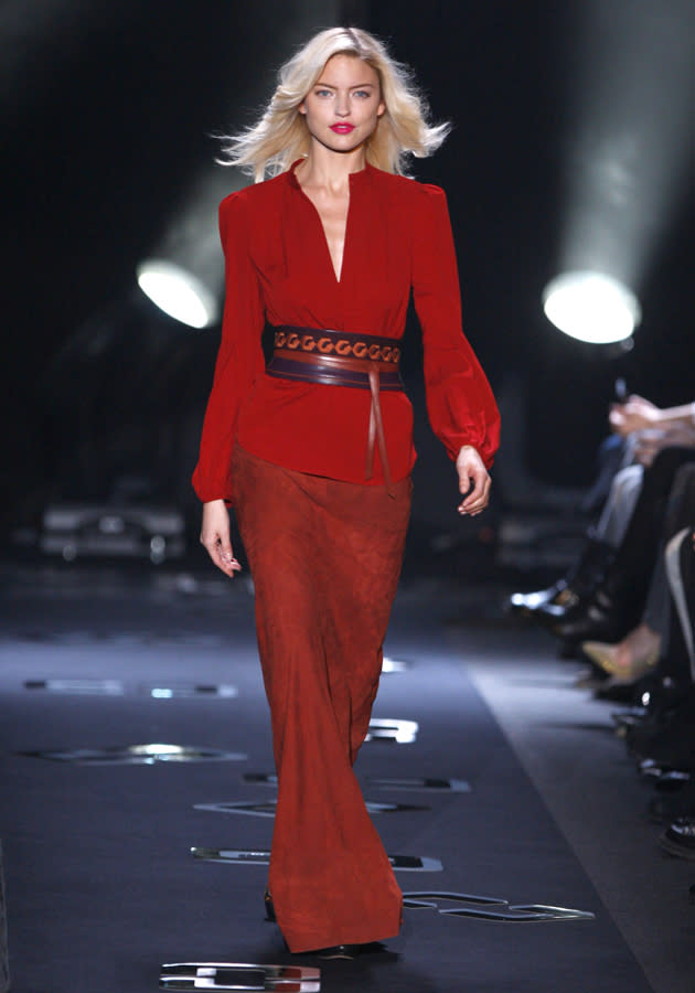 <b>Diane Von Furstenburg AW 13 runway show<br><br></b>A model shows off a feminine, loose-sleeved red blouse with maxi skirt - pulled in by a detailed leather belt at the waist.<br><br>©Rex<b><br></b>