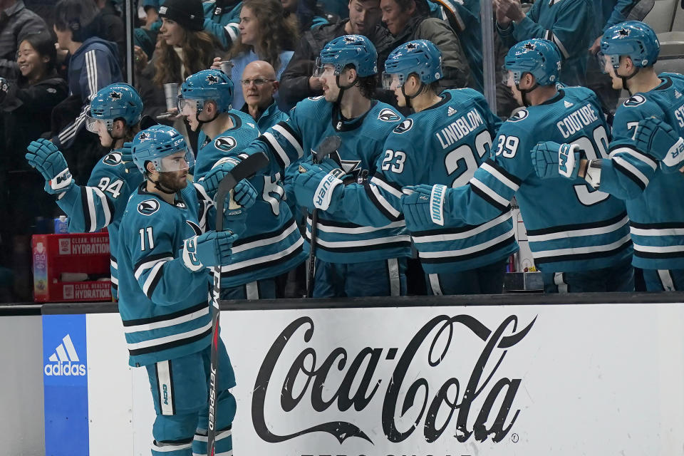 San Jose Sharks center Luke Kunin (11) is congratulated for his goal against the Anaheim Ducks during the second period of an NHL hockey game in San Jose, Calif., Saturday, Nov. 5, 2022. (AP Photo/Jeff Chiu)