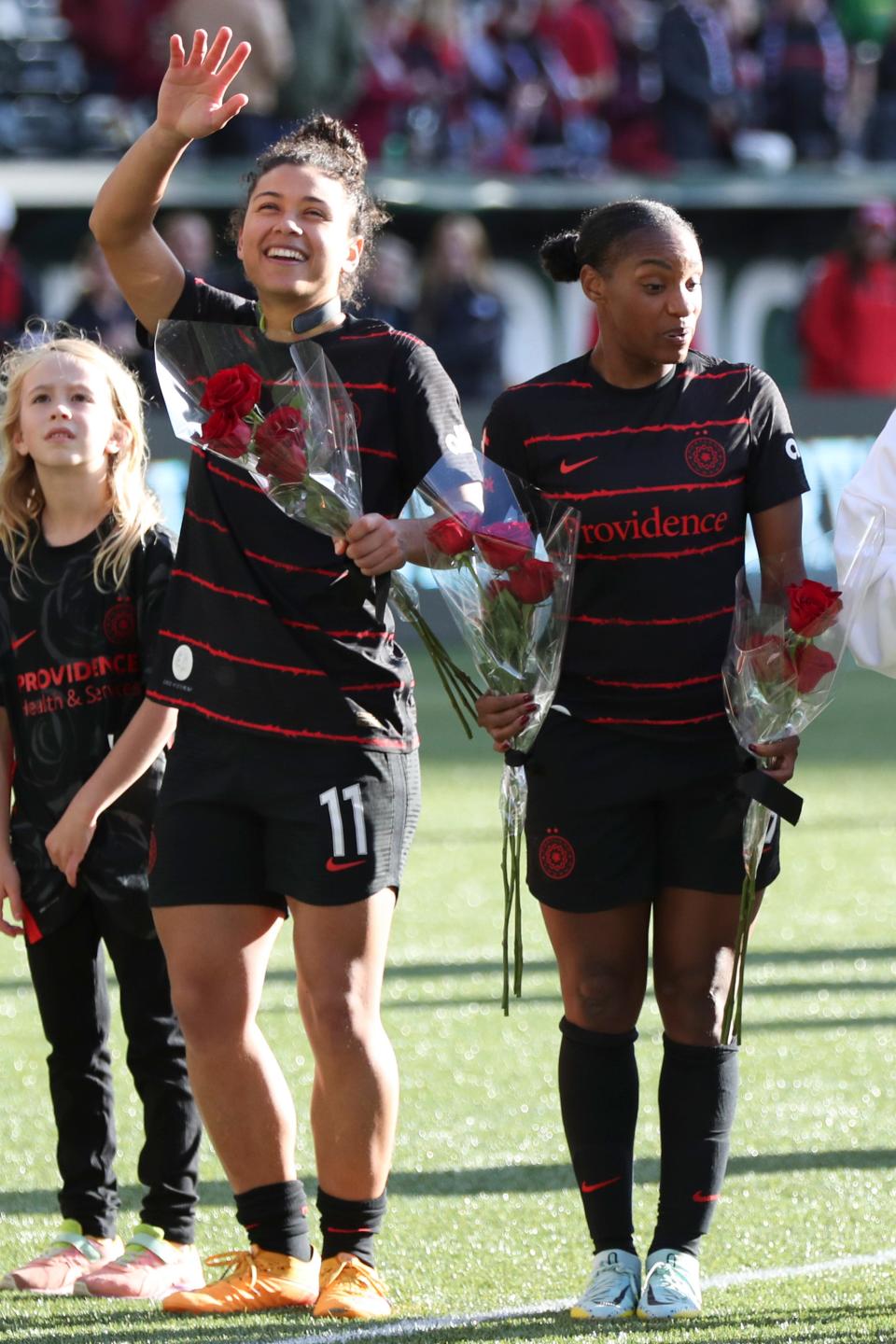 Raquel "Rocky" Rodríguez (11) and Crystal Dunn celebrate following their team's NWSL playoff win over San Diego Wave FC at Providence Park.