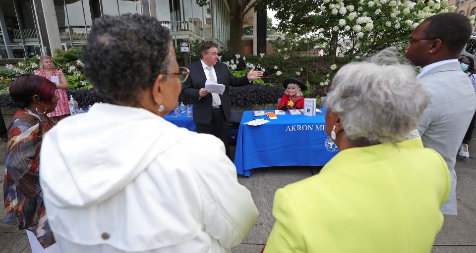 Akron Municipal Court Judge Ron Cable speaks about Ophelia Averitt as she looks on Wednesday outside the Harold K. Stubbs Justice Center.