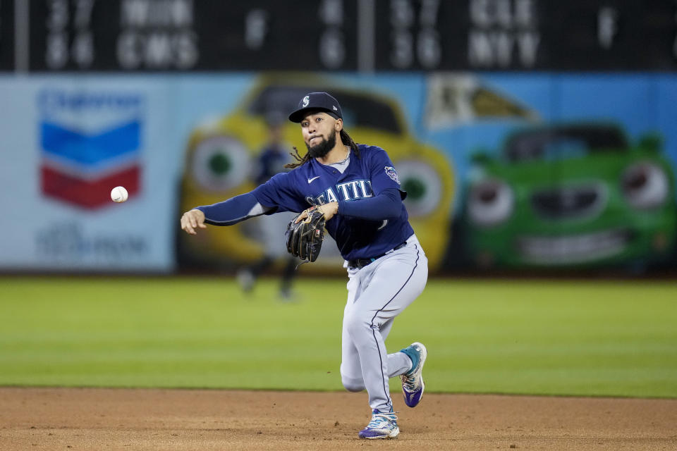 Seattle Mariners shortstop J.P. Crawford throws to first for an out on Oakland Athletics' JJ Bleday during the second inning of a baseball game in Oakland, Calif., Wednesday, May 3, 2023. (AP Photo/Godofredo A. Vásquez)