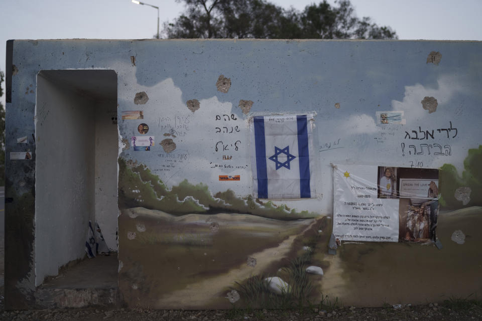 An Israeli flag hangs at the entrance of a damaged roadside bomb shelter where people were killed during the Hamas militants attack near the Israeli-Gaza border in Israel, Saturday, Jan. 6, 2024. At least, 1,200 people were killed in the Oct. 7 attack, which triggered the latest Israel-Hamas war, (AP Photo/Leo Correa)