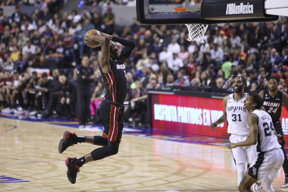 Miami Heat's Tyler Herro dunks the ball during the second half of an NBA basketball game against the San Antonio Spurs, at the Mexico Arena in Mexico City, Saturday, Dec. 17, 2022. (AP Photo/Christian Palma)