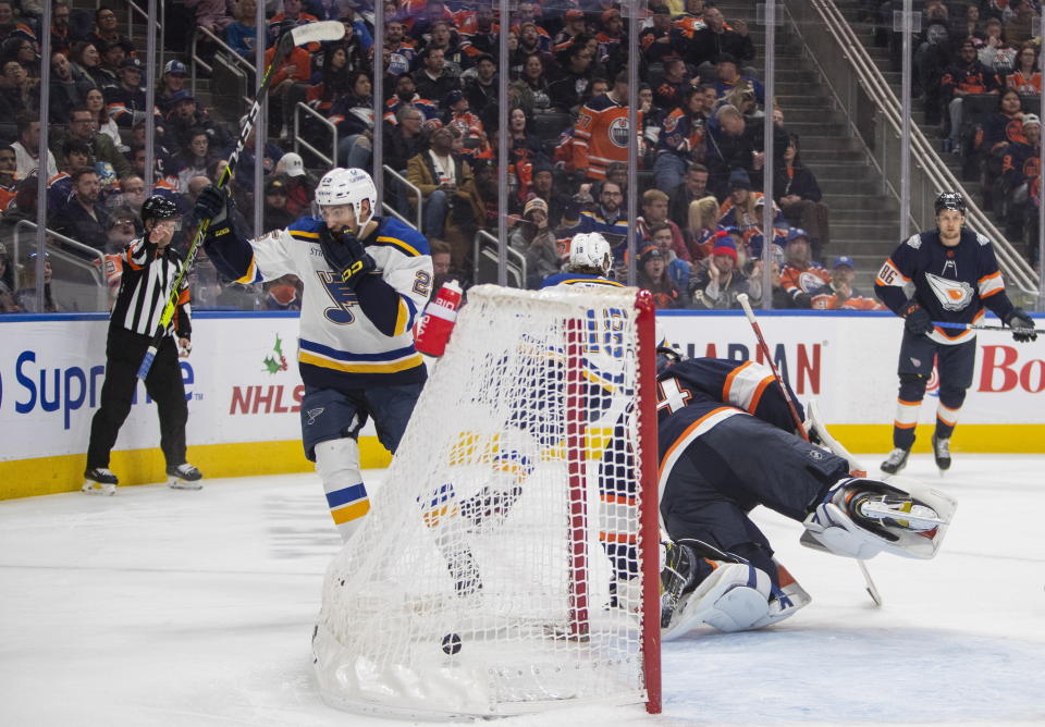 St. Louis Blues' Jordan Kyrou (25) celebrates a goal on Edmonton Oilers goalie Stuart Skinner (74) during the third period of an NHL hockey game, Thursday, Dec. 15, 2022 in Edmonton Alberta. (Amber Bracken/The Canadian Press via AP)