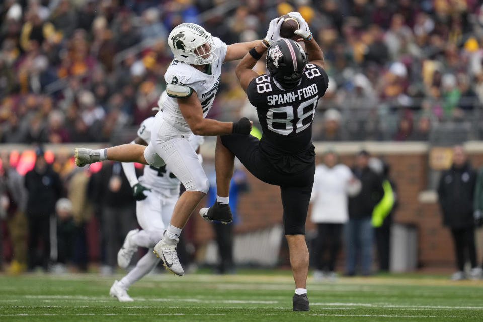 Minnesota tight end Brevyn Spann-Ford (88) catches a pass while defended by Michigan State linebacker Cal Haladay during the first half of an NCAA college football game Saturday, Oct. 28, 2023, in Minneapolis. (AP Photo/Abbie Parr)