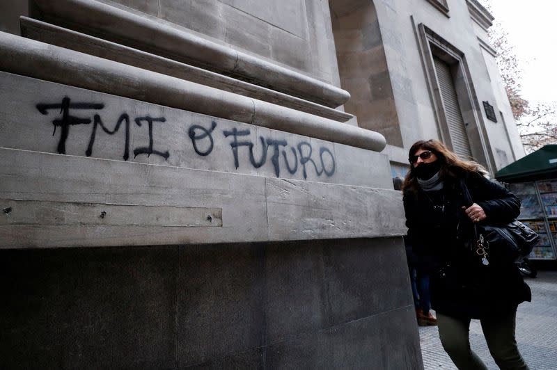 FILE PHOTO: Graffiti reads “IMF or future” outside Argentina’s Banco Nacion (National Bank) in Buenos Aires’ financial district