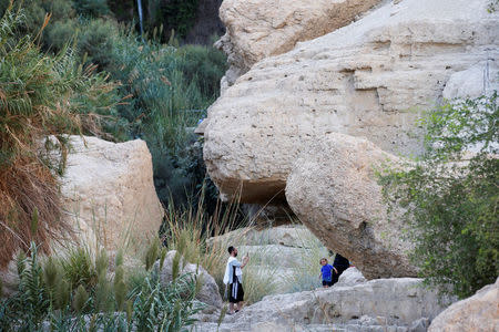 A man uses his mobile phone to take a picture as he visits Nahal David in the Ein Gedi Nature Reserve area, near the Dead Sea, Israel October 1, 2017. REUTERS/Ronen Zvulun