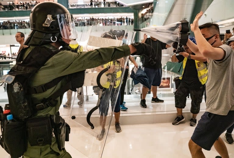 Hong Kong was reeling from fresh violence between protesters and police on Monday as it was reported that the city’s leader Carrie Lam had attempted to resign several times in recent weeks over the ongoing unrest.Ms Lam, appointed by Beijing, has admitted her government’s “total failure” in handling a proposed extradition bill that would have allowed the territory to deport criminal suspects to mainland China for trial.Public anger at the bill resulted in the worst disorder in decades, including a record protest march last month that had as many as two million participants.Amid the marches and international criticism of the heavy-handed conduct of police in dealing with protesters, Ms Lam repeatedly offered to step aside, according to a report in the Financial Times, only for Beijing to insist she stays on.The central government is of the view that “no one else can clean up the mess and no one else wants the job”, according to an unnamed official said to have direct knowledge of the situation.Ms Lam’s resignation has been one of the core demands of the protest movement since the unrest began, but the chief executive has repeatedly insisted she must be given the chance to win back Hong Kongers’ trust. The idea that she is in fact staying in power unwillingly will only make her position more untenable.Meanwhile, Ms Lam expressed concern for the safety of the city’s police officers after Sunday was marred by yet more clashes with demonstrators.The protest centred around a shopping complex in the northern Sha Tin district, popular with Chinese visitors, and was peaceful for most of the day until fights broke out when night fell and police started clearing the streets.Some protesters retreated into the shopping centre where they and police hit each other with clubs and umbrellas. Ms Lam called the latter group of protesters “rioters”, a legally loaded term in the city, and said she supported the police in upholding law and order.The chief executive visited a hospital where three police officers injured in the clashes were being treated. “We thank the police officers for maintaining social order loyally and professionally, but they have suffered in attacks from those rioters - they can be called rioters,” she said.After attempting to strike a note of contrition in the last two weeks, her shift to harder language risks raising tension. More demonstrations are planned for the coming days.Police Chief Stephen Lo said late on Sunday that more than 40 people were arrested on charges including assaulting police and illegal assembly. The government said 28 people, including 10 police, were injured in the clashes.Security chief John Lee said the government was concerned at an apparent escalation of violence by activists who threw bricks and iron bars."We found that people who attacked the police were very organised ... they are well-planned and there are plans to deliberately do damage and disrupt social stability," Lee said as he visited the hospital with Lam.Both pro-democracy legislators and politicians who support China's central government held news conferences to address the latest violence.Pro-democracy leader Claudia Mo described the current unrest as "the biggest political and governance crisis Hong Kong has ever faced”. "The whole of Hong Kong found it difficult to cope," she said. "We urge once again Carrie Lam to come out and face the people." And pro-Beijing politician Starry Lee called on both sides to “come out and establish communication channels”.“I think [Ms Lam] and also the bureau responsible should come out and respond to this issue," Lee said. “Otherwise Hong Kong will be the loser and no Hong Kong person wants to see this happen again and again.”