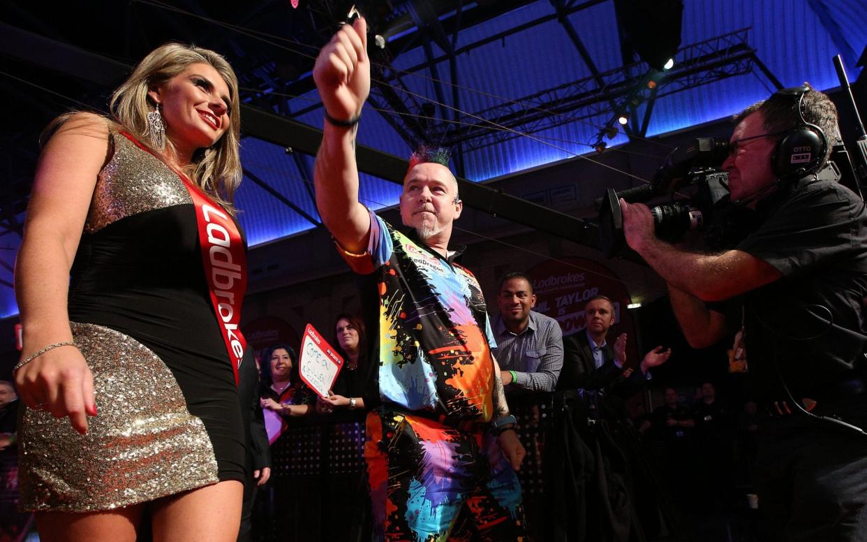 A walk-on girl on the stage with darts player Peter 'Snakebite' Wright during the world championship at Alexandra Palace in 2013