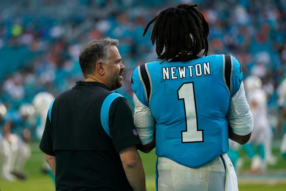 Carolina Panthers head coach Matt Rhule talks to quarterback Cam Newton (1) on the sideline after Newton came out during the second half of an NFL football game against the Miami Dolphins, Sunday, Nov. 28, 2021, in Miami Gardens, Fla. (AP Photo/Lynne Sladky)