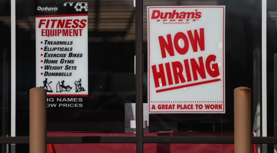 Signage seeking workers seen Tuesday, Jan. 11, 2022, at Dunham's Sports in Lansing.