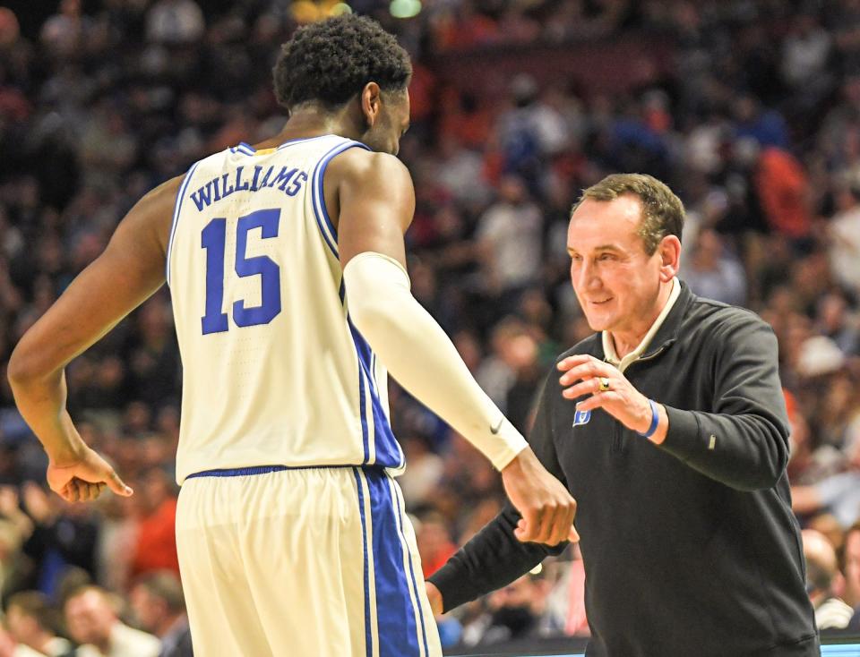 Mike Krzyzewski prepares to hug Mark Williams in the closing seconds of a 85-76 win over Michigan State.