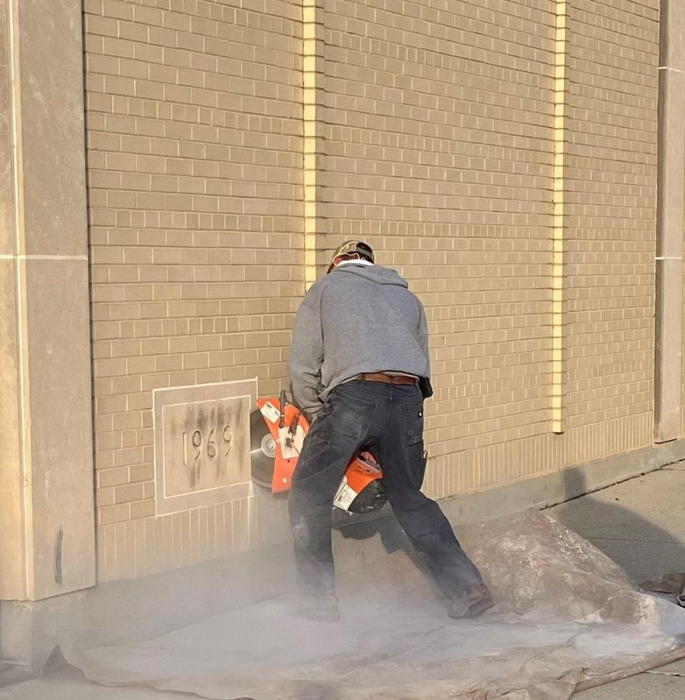 Randy Brice of Brice Masonry cuts out the cornerstone of the Green Bay Press-Gazette production facility on April 12, 2024. In 1969, the Press-Gazette placed a time capsule in the cornerstone vault.