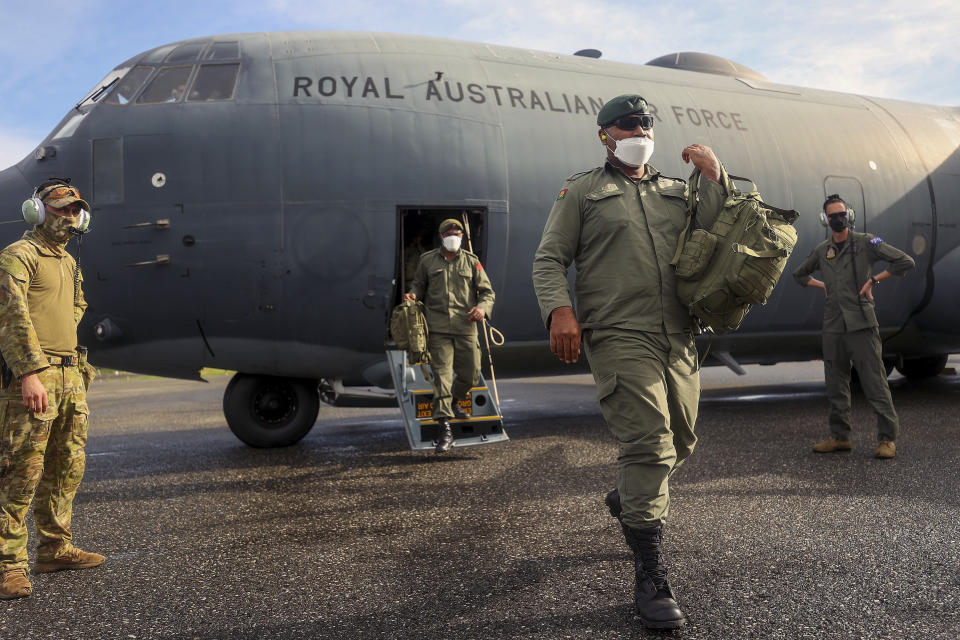 Fiji soldiers disembark from an Australian Air Force C130 in Honiara, Solomon Islands, Tuesday, Nov. 30, 2021. New Zealand announced Wednesday, Dec. 1, 2021, that they will send up to 65 military and police personnel to the Solomon Islands over the coming days after rioting and looting broke out there last week.(Gary Ramage via AP)