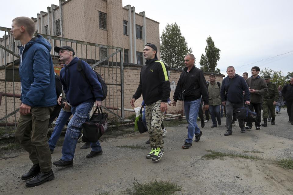 FILE Russian recruits walk past a military recruitment center in Volgograd, Russia, Saturday, Sept. 24, 2022. Russian President Vladimir Putin on Wednesday ordered a partial mobilization of reservists to beef up his forces in Ukraine. (AP Photo, File)