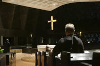 Benedictine monks gather for evening prayers in the mid-20th century church next to their abbey on the campus of Saint John's University in Collegeville, Minnesota, on Tuesday, Nov. 8, 2022. The school, and its twin institution for women, the College of Saint Benedict, have made efforts to welcome and affirm LGBTQ students, a fraught concern for Catholic colleges across the country. (AP Photo/Giovanna Dell'Orto)