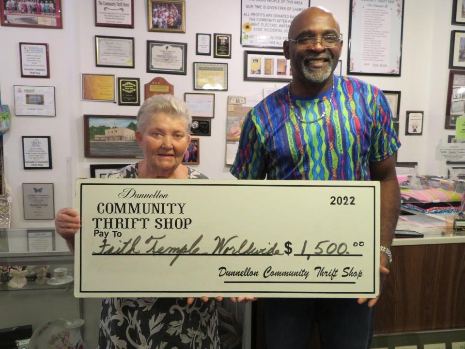 Dunnellon Community Thrift Shop volunteer Rose Kleuker presents a $1,500 check to Pastor Freddie Oats of the Faith Temple World Wide Ministries Community Outreach, which supplies supplemental food to more than 80 families.