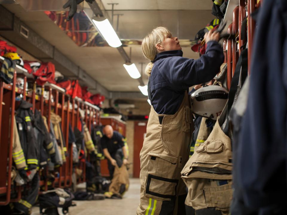 Female firefighter changing clothes in locker