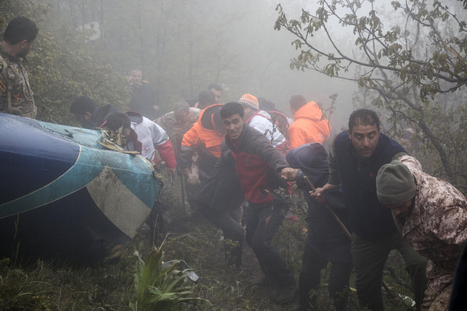 In this photo provided by Moj News Agency, rescue team members work at the scene of a crash of a helicopter carrying Iranian President Ebrahim Raisi in Varzaghan in northwestern Iran, Monday, May 20, 2024. Raisi, the country’s foreign minister and several other officials were found dead on Monday, hours after their helicopter crashed in a foggy, mountainous region of the country’s northwest, state media reported. (Azin Haghighi, Moj News Agency via AP)