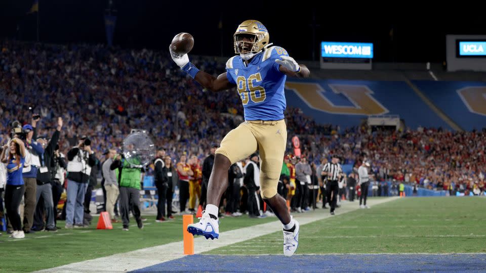 Michael Ezeike of the UCLA Bruins celebrates a touchdown against the USC Trojans. - Harry How/Getty Images