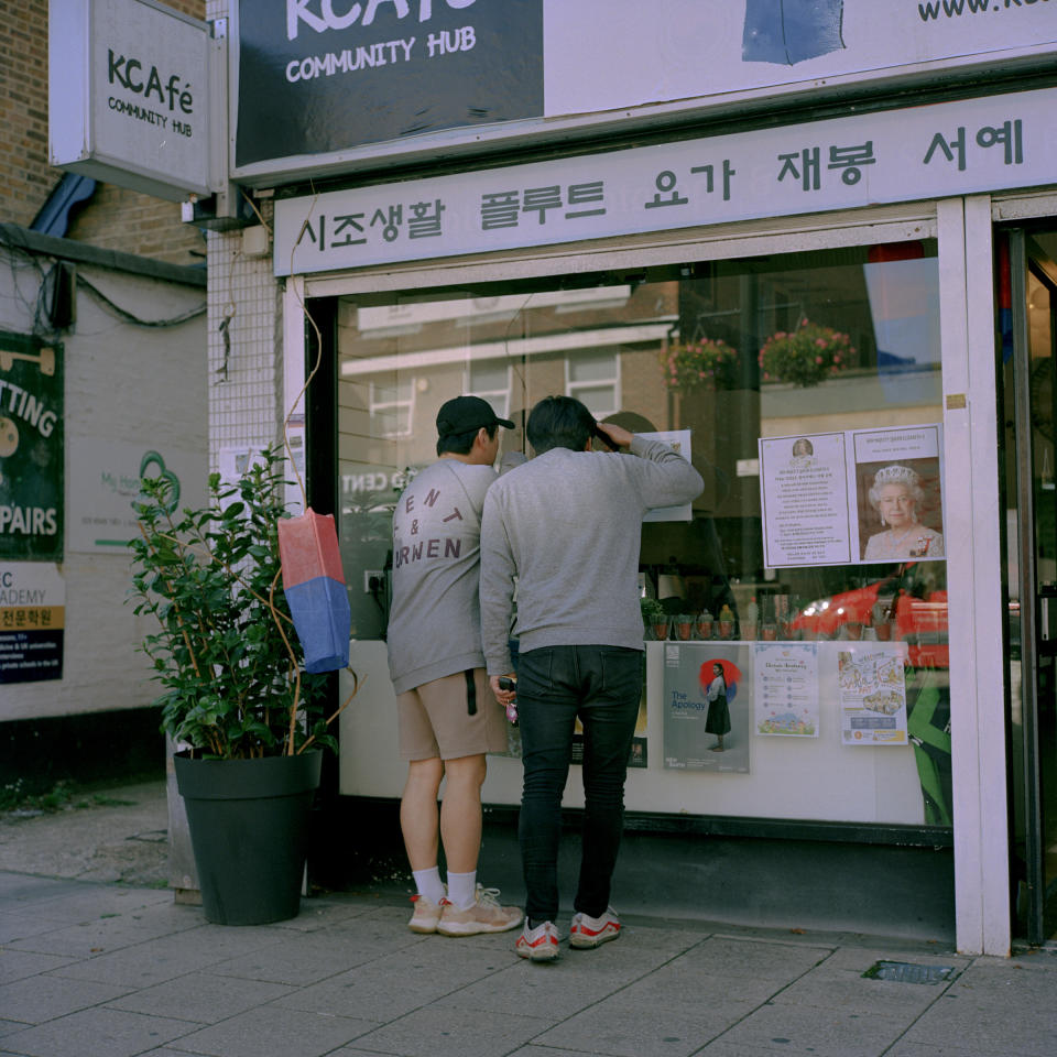 Two young Koreans look inside the Korean Culture & Art Centre in New Malden.<span class="copyright">Michael Vince Kim for TIME</span>