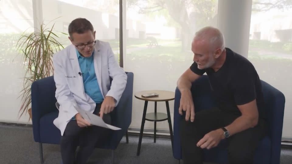 Dr. Richard Isaacson, left, discusses test results with Simon Nicholls, participant No. 34 in his clinical trial. - CNN