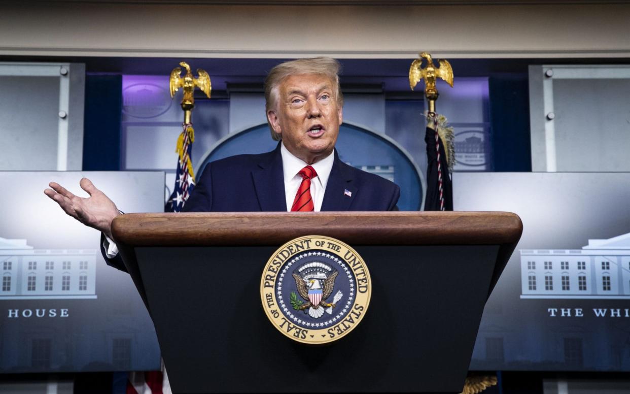 Donald Trump at the White House briefing room podium -  Al Drago/Bloomberg
