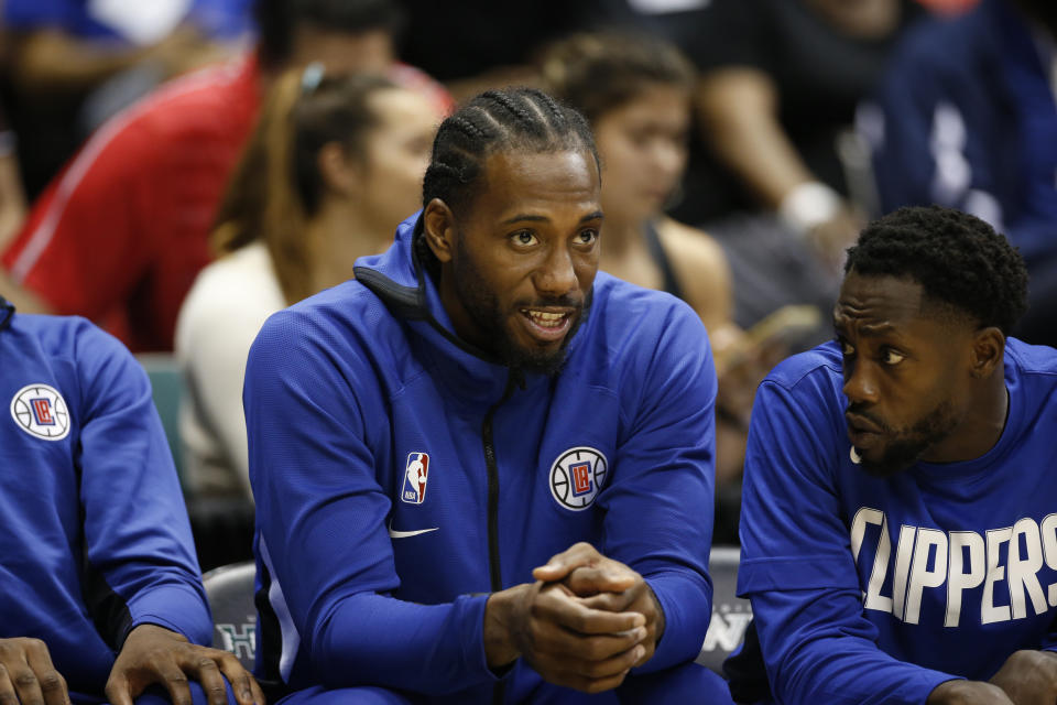 Los Angeles Clippers small forward Kawhi Leonard (2) sits on the bench during an NBA preseason basketball game against the Houston Rockets, Thursday, Oct 3, 2019, in Honolulu. (AP Photo/Marco Garcia)
