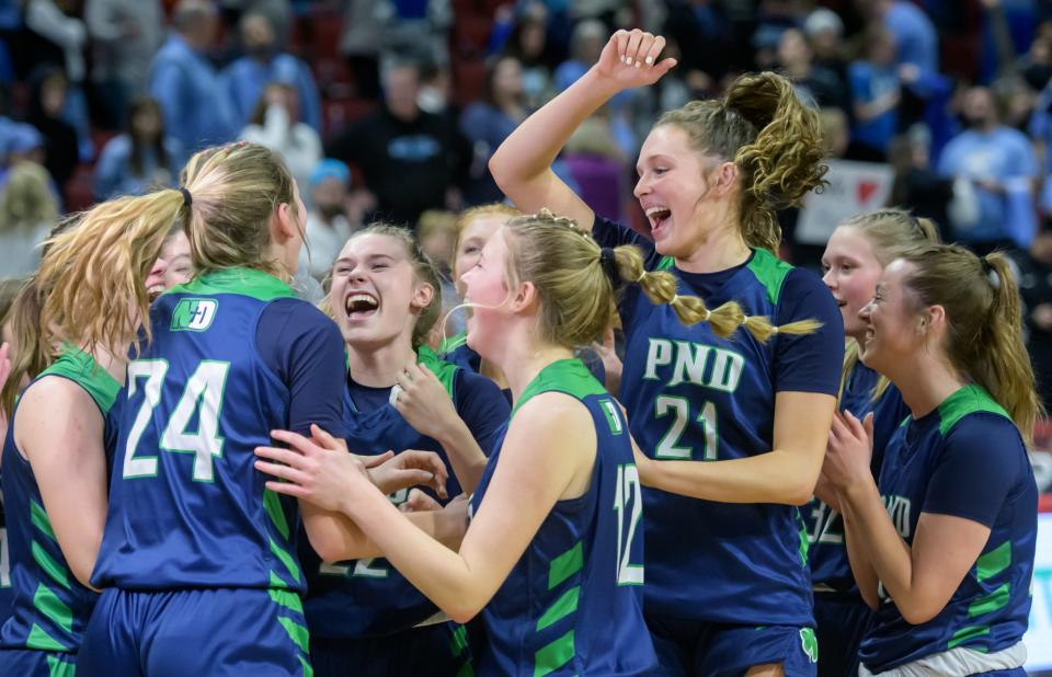 The Peoria Notre Dame Irish celebrate their 71-25 win over Wilmette Regina Dominican in the Class 2A girls basketball state semifinal Thursday, Feb. 29, 2024 at CEFCU Arena in Normal.